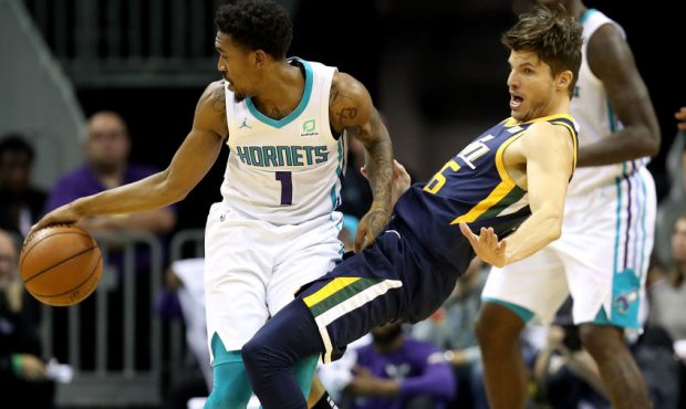 Malik Monk #1 of the Charlotte Hornets runs into Kyle Korver #26 of the Utah Jazz during their game...