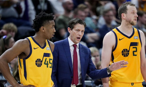 Utah Jazz head coach Quin Snyder talks to guard Donovan Mitchell (45) and center Rudy Gobert (27) d...