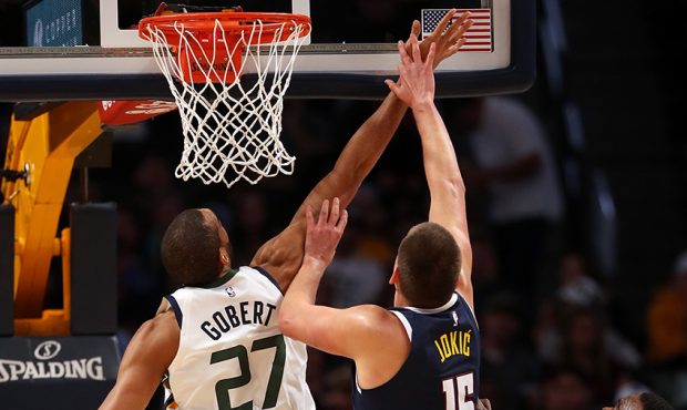 Rudy Gobert #27 of the Utah Jazz puts up a shot against Nikola Jokic #15 and Paul Millsap #4 of the...