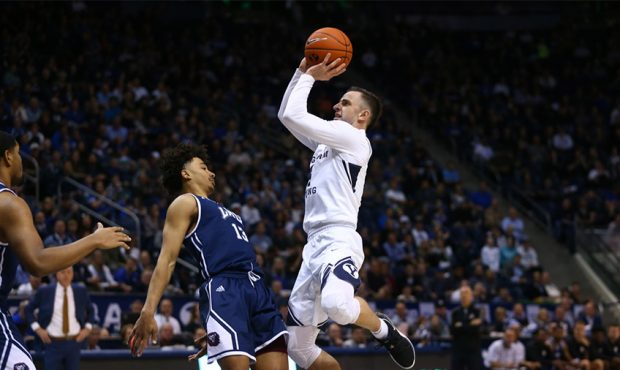 Brigham Young Cougars guard Nick Emery (4) taks a jump shot while guarded by Loyola Marymount Lions...