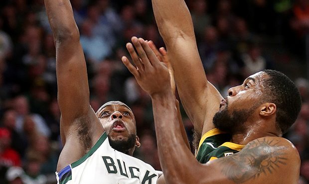 Utah Jazz forward Derrick Favors (15) blocks a shot by Milwaukee Bucks forward Khris Middleton (22)...