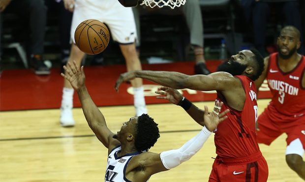 Houston Rockets guard James Harden (13) blocks a shot attempt by Utah Jazz guard Donovan Mitchell (...