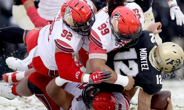 Quarterback Steven Montez #12 of the Colorado Buffaloes is is sacked by Maxs Tupai #92, Leki Fotu #...