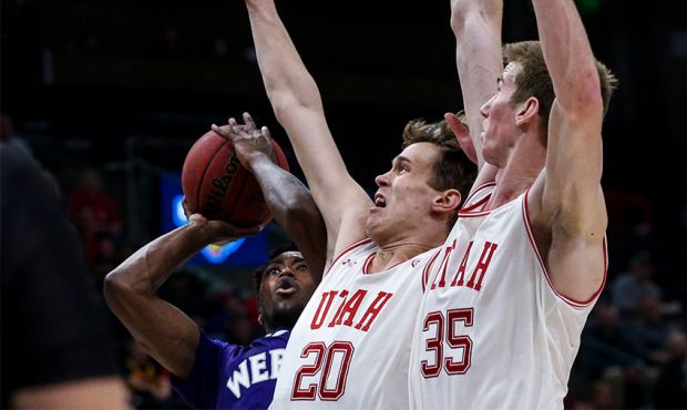 Weber State Wildcats guard Kham Davis (4) is blocked under the basket by Utah Utes forward Mikael J...