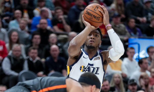 Utah Jazz guard Donovan Mitchell (45) shoots over Orlando Magic forward Aaron Gordon (00) after he ...