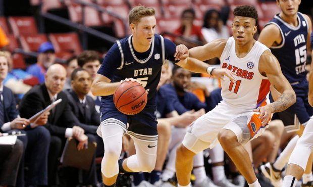 Sam Merrill #5 of the Utah State Aggies dribbles with the ball against the Florida Gators during th...