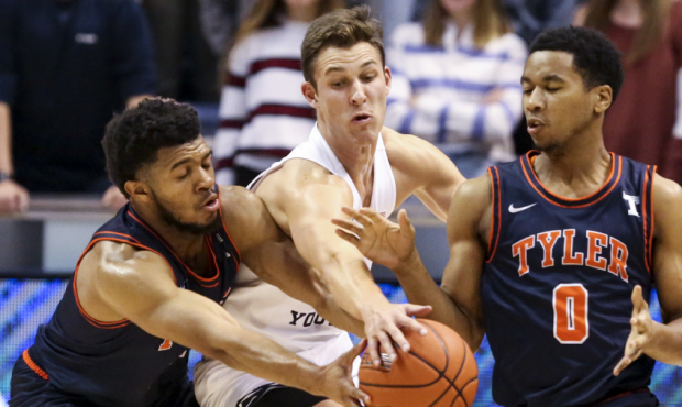 Brigham Young Cougars guard Trevin Knell (21) steals the ball from between UT-Tyler guards Micah Fu...