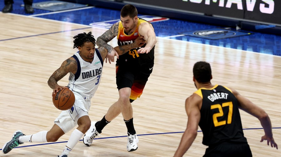Dallas Mavericks guard Trey Burke drives against Utah Jazz forward Juancho Hernangomez (Photo by To...