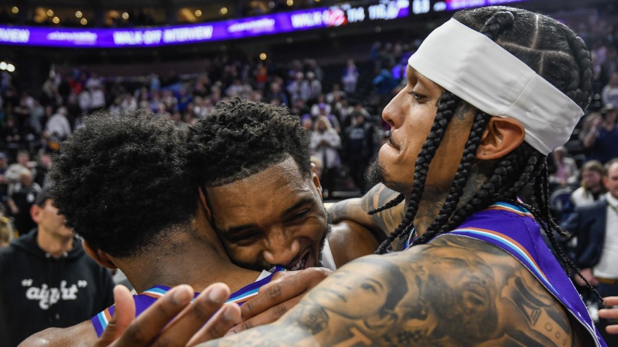 Mike Conley, Jordan Clarkson, and Donovan Mitchell hug after the Utah Jazz beat the Cleveland Caval...