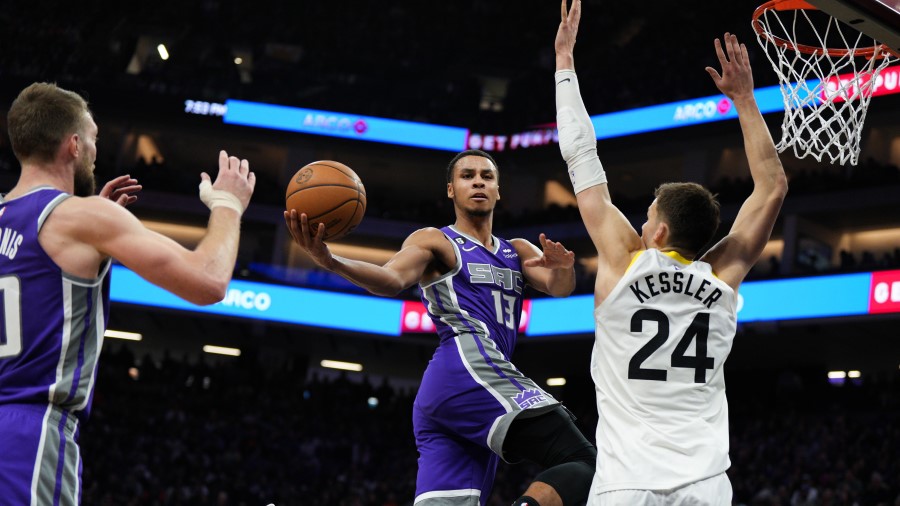 Keegan Murray #13 of the Sacramento Kings drives toward the basket as Walker Kessler #24 of the Uta...