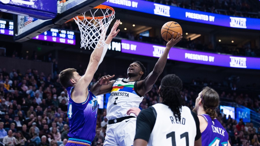 Minnesota Timberwolves guard Anthony Edwards (1) lays the ball up past Utah Jazz center Walker Kess...