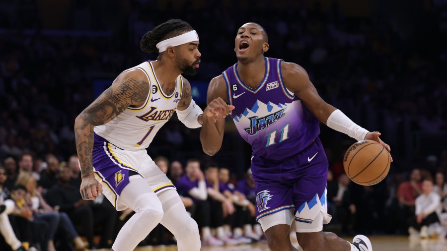 Kris Dunn #11 of the Utah Jazz reacts as he drives past D'Angelo Russell #1 of the Los Angeles Lake...