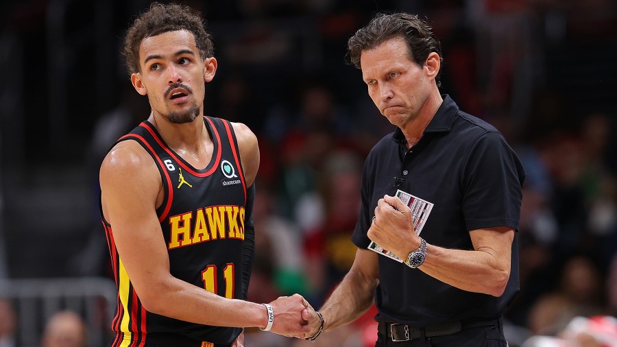 Head coach Quin Snyder of the Atlanta Hawks reacts with Trae Young #11 against the Boston Celtics d...