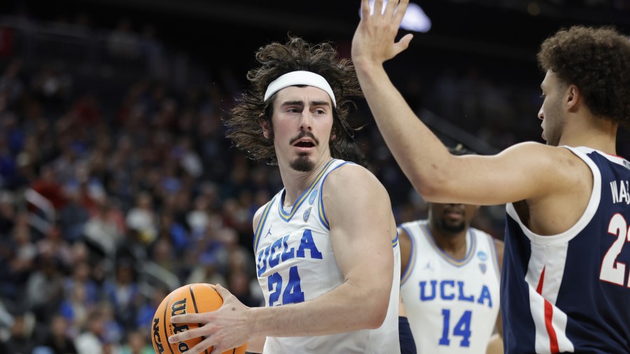 Jaime Jaquez Jr. #24 of the UCLA Bruins drives to the basket...